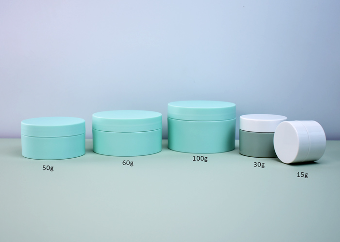 cylinder thick wall plastic cosmetic jar with lids sitting flush on the side
