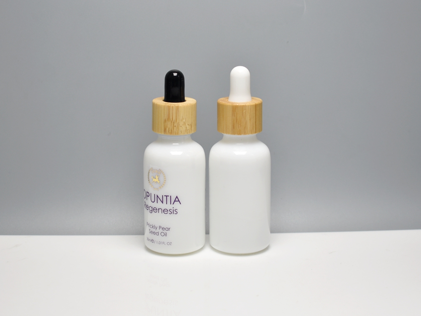 opaque white glass cosmetic bottles matched with glass dropper which assembled with bamboo collar