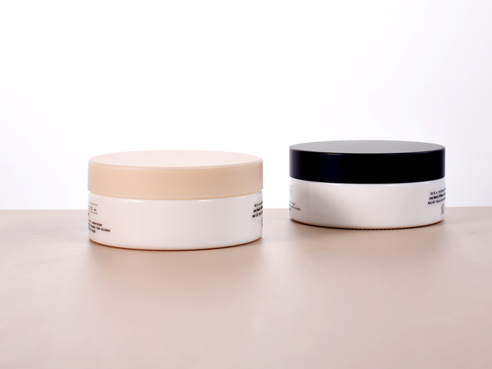 120ml low profile round glass jar in white with pink and dark blue lid, as primary packaging solutions for skincare, and personal care.