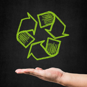 hand-with-recycling-symbol-drawn-blackboard