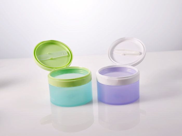 100ml round empty plastic cosmetic jar with flip top cap and tweezer/spatula, as packaging solutions for cleansing balms and toner pads.