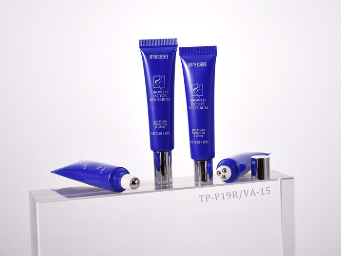 Blue skincare tubes labeled Growth Factor Eye Serum on a white display stand, with two upright and two lying down.